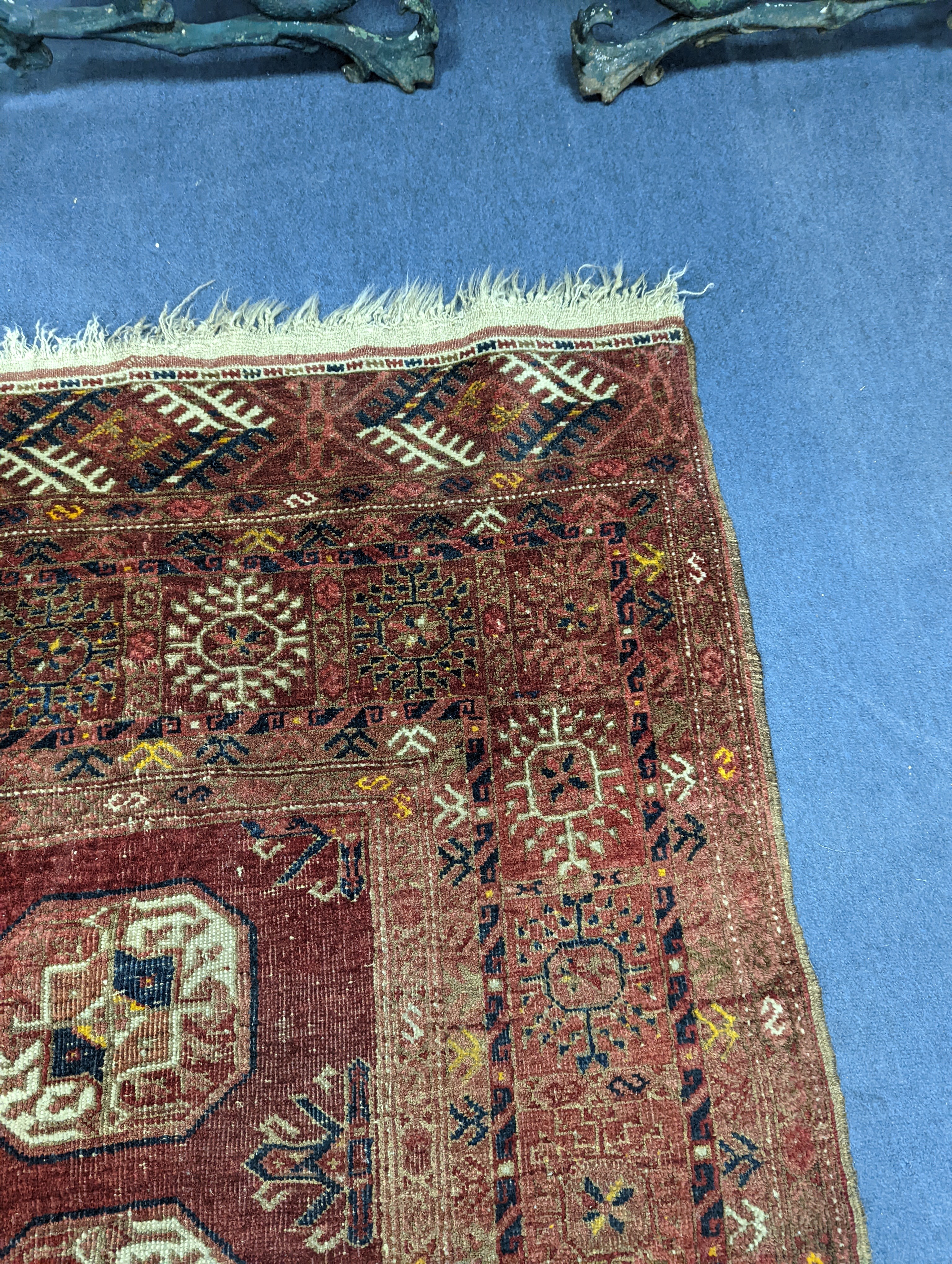 A Bokhara red ground rug, 200 x 114cm